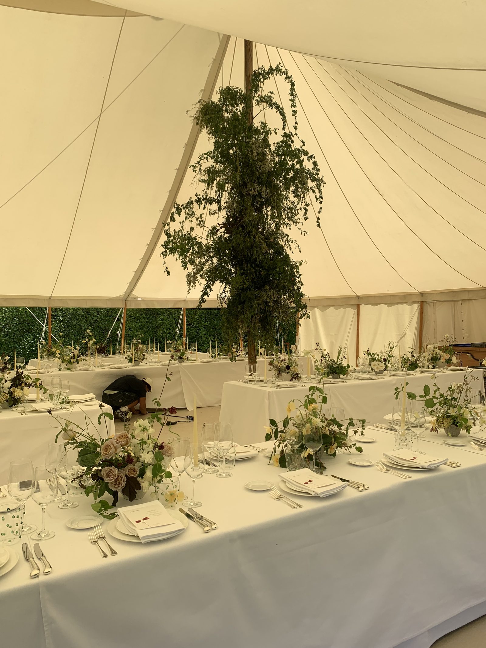 Hanging greenery and floral installation in a marquee